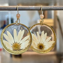 Load image into Gallery viewer, Earrings with pressed flowers in clear resin and circular brass settings.