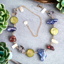 Load image into Gallery viewer, A colorful pearl necklace with a mix of blue, green, red, and white pearls, along with other semiprecious stones, gold-filled wire, and beads.