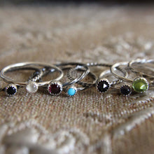 Load image into Gallery viewer, Set of silver rings with gemstones on a textured fabric background
