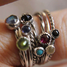 Load image into Gallery viewer, Close-up of fingers wearing a set of 5 gemstone stackable rings in sterling silver, featuring various gemstone colors and band styles.
