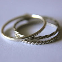 Load image into Gallery viewer, three silver rings with textured designs on a light gray background