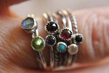 Load image into Gallery viewer, Set of 5 gemstone stackable rings in sterling silver on a finger, featuring colorful gemstones in plain, rope, and twist band styles.
