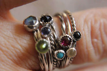 Load image into Gallery viewer, Close-up of fingers wearing a set of 5 gemstone stackable rings in sterling silver, featuring various gemstone colors and band styles.
